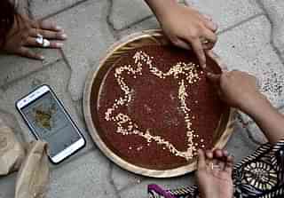Students doing art work with millets during a Millet Workshop for Nutrition. (Arijit Sen/Hindustan Times via Getty Images) 