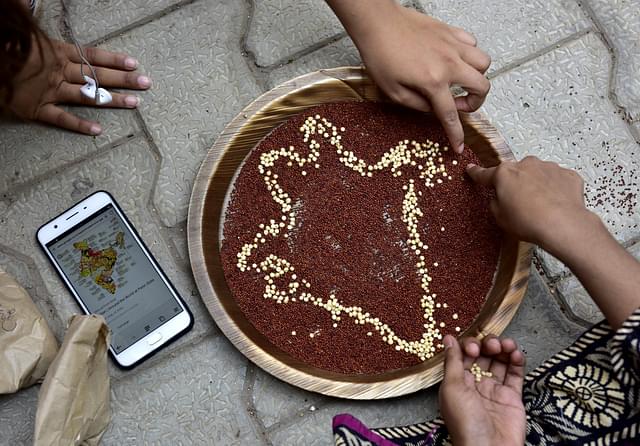 Students doing art work with millets during a Millet Workshop for Nutrition. (Arijit Sen/Hindustan Times via Getty Images) 