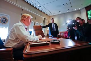 President Donald Trump sits at his desk on Air Force One.