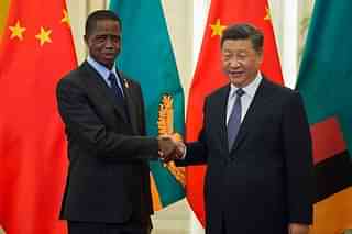 Zambia’s President Edgar Lungu (L) shake hands with China’s President Xi Jinping (R) (Photo by Nicolas Asfouri-Pool/Getty Images)