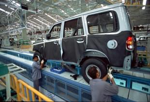 Employees working at an assembly line at Mahindra and Mahindra Plant in Nashik, India. Industrial Shot (Sanjay Pandya/The India Today Group/Getty Images)