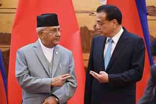 Nepal’s Prime Minister K.P. Sharma Oli (L) chats with Chinese Premier Li Keqiang at the Great Hall of the People on 18 June 2018. (Greg Baker-Pool/Getty Images)&nbsp;