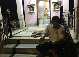 Padelkar sits at the temple steps as he awaits his team to gather.
