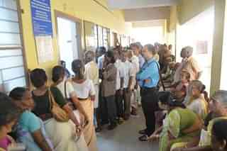 Pensioners waiting in queue for payment.