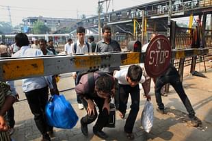 The Level Crossing Gate has been closed since long but people still cross tracks at Kandivali station on Tuesday. (Sattish Bate/Hindustan Times via Getty Images) 