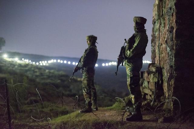 Indian Army soldiers at forward posts beyond the illuminated fence. (Gurinder Osan/Hindustan Times via Getty Images)&nbsp;