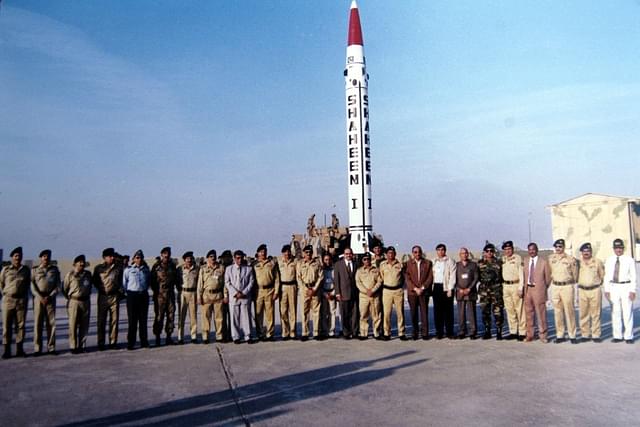 In this photo dated 8 December 2004, Pakistani defence officials pose with an indigenous short-range, nuclear missile at an undisclosed location. (Photo by Pakistan Ministry of Defence via Getty Images)