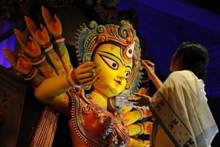 Bengal Chief Minister Mamata Banerjee sketches the eyes of Goddess Durga (Subhendu Ghosh/Hindustan Times via Getty Images) 