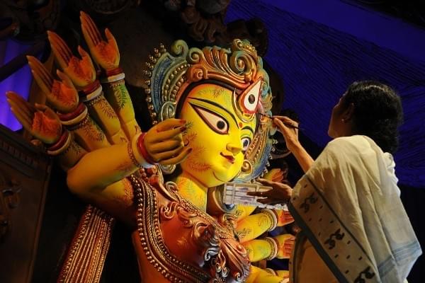 Bengal Chief Minister Mamata Banerjee sketches the eyes of Goddess Durga (Subhendu Ghosh/Hindustan Times via Getty Images) 
