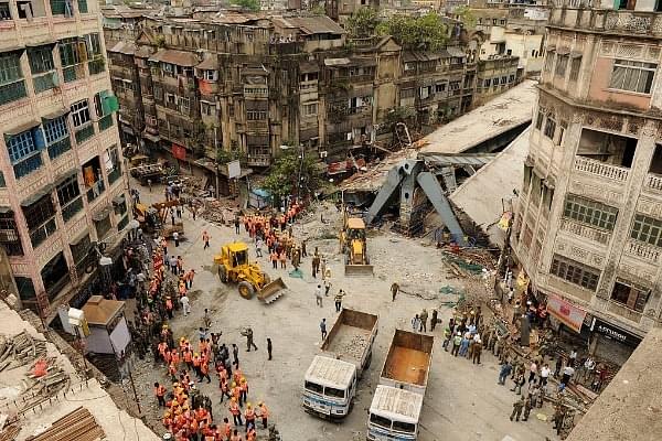 NDRF and Civil Defence rescue teams clearing the debris of an under-construction flyover which collapsed on Vivekananda road on 1 April 2016 in Kolkata. At least 25 people were killed and over 60 others injured as the flyover, which was still under construction, collapsed. (Photo by Samir Jana/Hindustan Times via Getty Images)