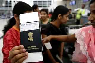 An Indian woman holds up her passport (SAFIN HAMED/AFP/Getty Images)