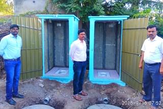 Officials with the readymade toilets being provided as part of the ODF campaign.