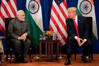 US President Donald Trump (R) speaks with Indian Prime Minister Narendra Modi (Photo by JIM WATSON/AFP/Getty Images)
