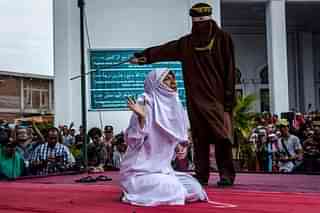 Representative image: An acehnese woman gets caned in public for spending time with a man who is not her husband (Photo by Ulet Ifansasti/Getty Images)&nbsp;