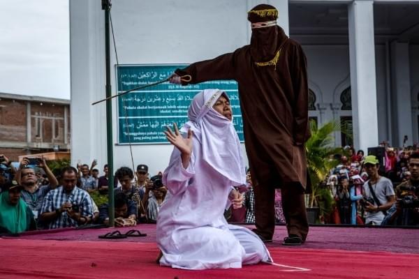 Representative image: An acehnese woman gets caned in public for spending time with a man who is not her husband (Photo by Ulet Ifansasti/Getty Images) 