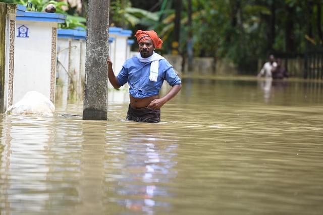  Residents wade through flood water on the outskirts of Chengannur Taluk on August 19, 2018 in Alappuzha (Raj K Raj/Hindustan Times via Getty Images)