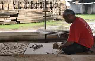 Worker cutting stone in workshop for preparation to build Ram temple (Burhaan Kinu/Hindustan Times via Getty Images)