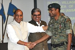 Home Minister Rajnath Singh shakes hands with a CRPF Commando after giving him medal at the CRPF Valour Day (Vipin Kumar/Hindustan Times via Getty Images)