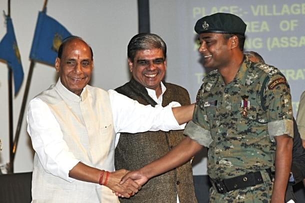 Home Minister Rajnath Singh shakes hands with a CRPF Commando after giving him medal at the CRPF Valour Day (Vipin Kumar/Hindustan Times via Getty Images)