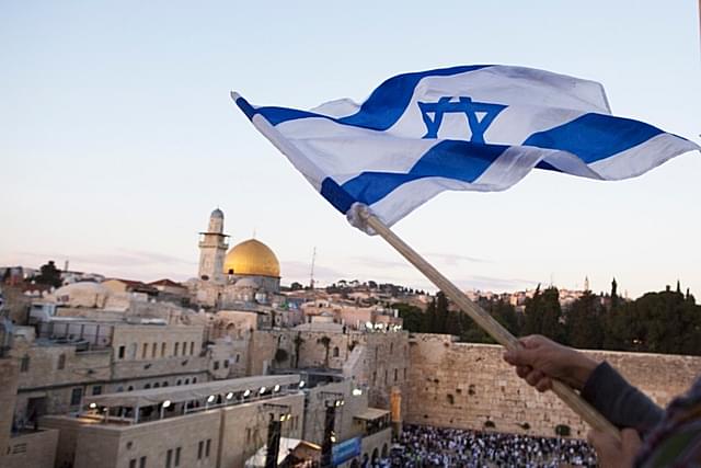 Israelis wave their national flags during a march next to the Western Wall as a part of observing the Jerusalem Day (Lior Mizrahi/Getty Images)