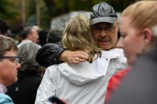 People comfort each other at the site of a mass shooting at the Tree of Life Synagogue in the Squirrel Hill neighbourhood on October 27, 2018 in Pittsburgh, Pennsylvania. (Photo by Jeff Swensen/Getty Images)