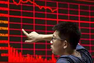 Chinese day trader reacts as he watches a stock ticker at a local brokerage house (Kevin Frayer/Getty Images)