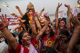 Hindu devotees chant prior to immersing an idol of Goddess Durga into the Yamuna river on the last day of the Durga Puja. (Daniel Berehulak/Getty Images)