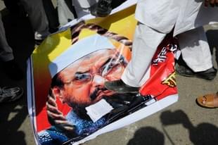 Protesters step on a poster featuring Lashkar-e-Taiba’s Chief Hafiz Saeed during an agitation in New Delhi (Photo by Pankaj Nangia/India Today Group/Getty Images)