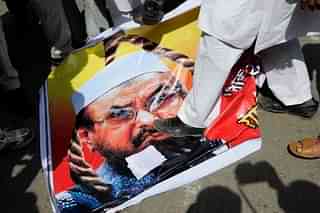 Protesters step on a poster featuring Lashkar-e-Taiba’s Chief Hafiz Saeed during an agitation in New Delhi  (Photo by Pankaj Nangia/India Today Group/Getty Images)
