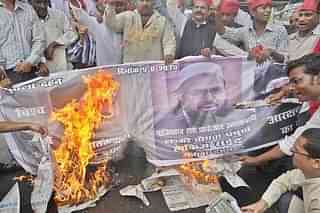 Protesters burn a Hafiz Saeed banner (Raj K Raj/Hindustan Times via Getty Images)