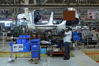 Indian workers labour on assembly lines of components for Datsun Go and Renault Kwid vehicles (ARUN SANKAR/AFP/Getty Images)