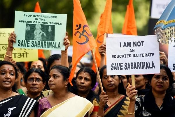 Members of Ayyappa Dharma Samrakshana Samithi hold placards during a protest against the Supreme Court verdict on the entry of women of all ages into the Sabarimala Lord Ayyappa Temple in New Delhi. (Amal KS/Hindustan Times via Getty Images)