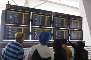 The passengers looking at flight schedule display at T-3 terminal Indira Gandhi International Airport. (Sushil Kumar/Hindustan Times via GettyImages)
