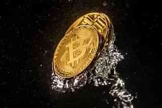 A visual representation of the digital currency Bitcoin sinks into water. (Dan Kitwood/Getty Images)