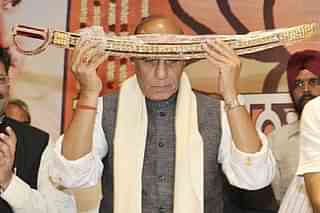 Rajnath SIngh holding a ceremonial sword (Munish Byala/Hindustan Times via Getty Images)