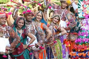 Men and women performing dandiya at the Navratri festival in Ahmedabad, Gujarat. (Shailesh Raval/The India Today Group/GettyImages)