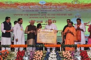 Prime Minister Narendra Modi gives a certificate of Prime Minister’s Housing Scheme during a public meeting, on September 23, 2017 in Varanasi. (Rajesh Kumar/Hindustan Times via Getty Images)
