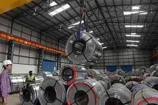 Indian workers store steel coils unloaded at a new private freight terminal near Ahmedabad. (SAM PANTHAKY/AFP/GettyImages) (representative picture)