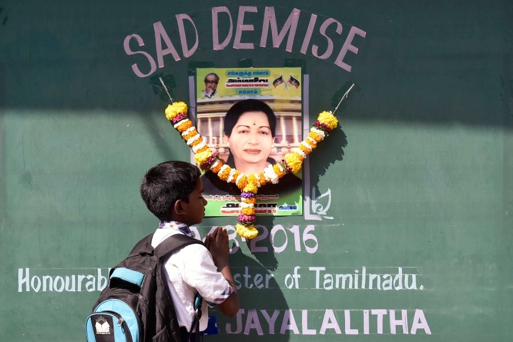 A supporter of Tamil Nadu Chief Minister J Jayalalithaa pays tributes near her photograph. (Kunal Patil/Hindustan Times via Getty Images)
