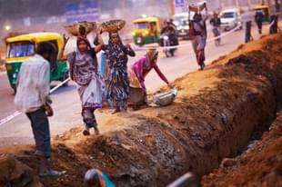 Migrant workers at a construction site in front of the Jawaharlal Nehru Stadium in New Delhi. (Daniel Berehulak/GettyImages) 