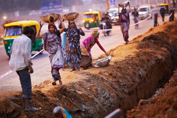 Migrant workers at a construction site in front of the Jawaharlal Nehru Stadium in New Delhi. (Daniel Berehulak/GettyImages) 