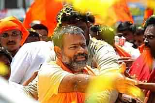 Swami Paripoornananda embracing supporters (Pic: Facebook)