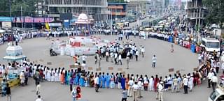 Health department contract workers stage a demonstration at a traffic junction in Vijayapura.&nbsp;