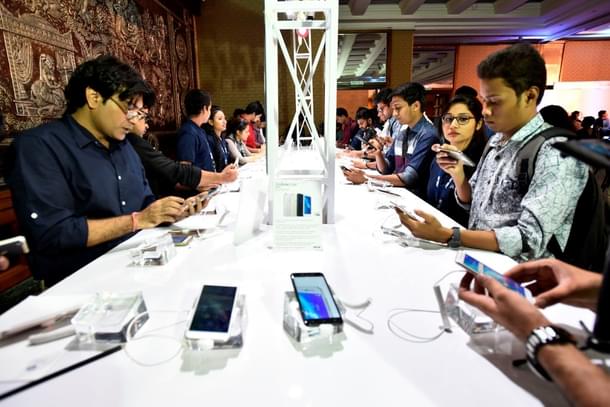 People at a smartphone store in India. (Photo by Burhaan Kinu/Hindustan Times via Getty Images. 