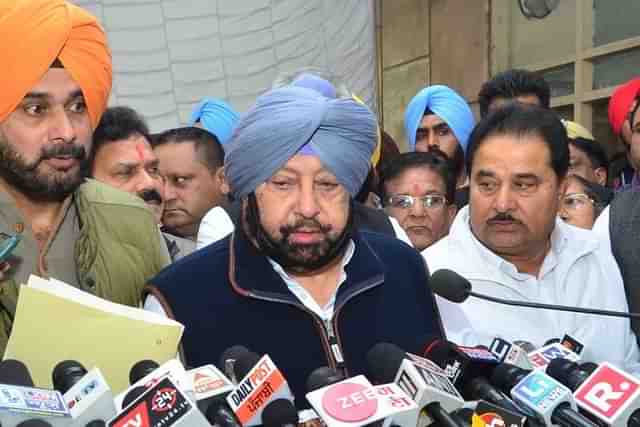 Punjab Chief Minister Amarinder Singh with Navjot Singh Sidhu. (Sameer Sehgal/Hindustan Times via Getty Images)