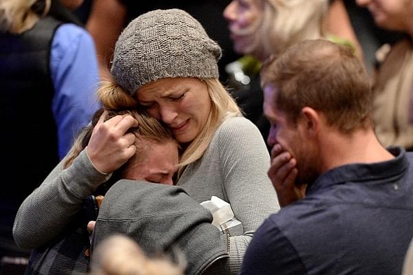 Mourners cry and comfort each other during a vigil for the victims (Kevork Djansezian/Getty Images)
