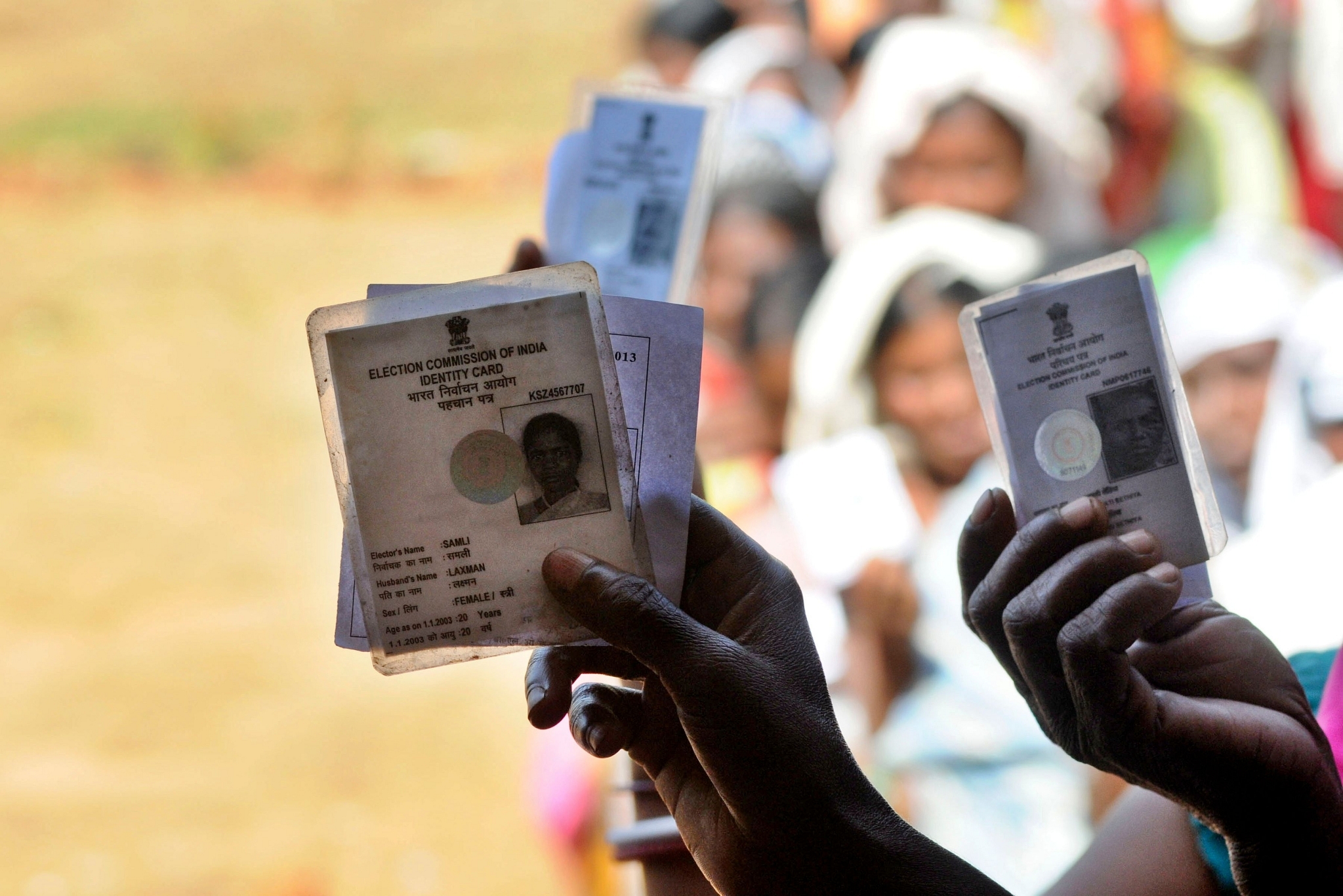 Voters showing voter ID card while standing in queue to cast their vote - Represenative Image (Parwaz Khan/Hindustan Times via GettyImages)