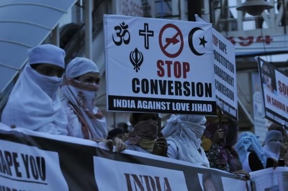 Women against love jihad hold placards to protest against the practice and conversion in Bhopal. (Mujeeb Faruqui/Hindustan Times via Getty Images) 