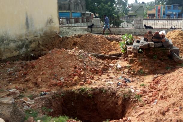 The earth has been dug up for the construction of a temple kitchen. Donations for the construction aren’t forthcoming, though.