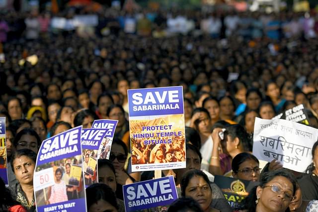 Members of Ayyappa Dharma Samrakshana Samithi hold placards during a protest. (Photo by Amal KS/Hindustan Times via Getty Images)&nbsp;
